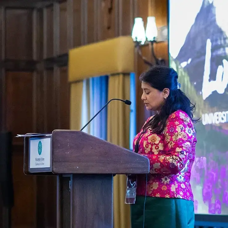 A woman speaks at a podium