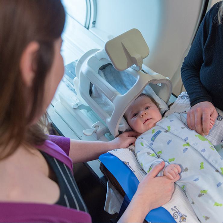 Mother and Center staff with infant for Baby Brain and Behavior Project